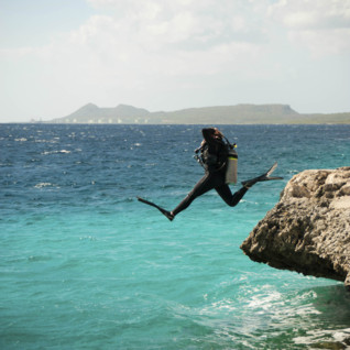 Diver jumping into water