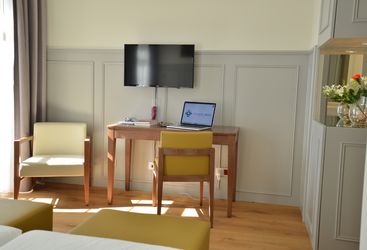 Standard bedroom with tv and desk
