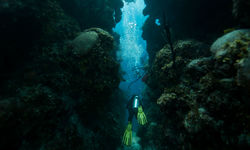 diver swimming through channel