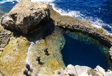 divers about to enter the water in Gozo