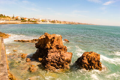 Ocean waves hitting a rock, on the Estoril coast, Portugal, Europe