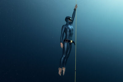 Free diver ascending along the rope.