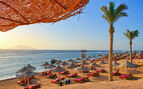 Idylic beach with palms and sun umbrelas, Red Sea, Egypt