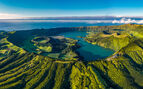 Aeriel view of the lush green mountains of the azores surrounding a lake