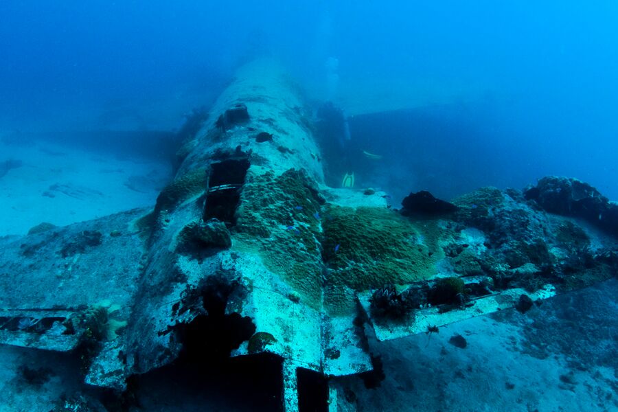 sunken airplane wreck in dark blue waters
