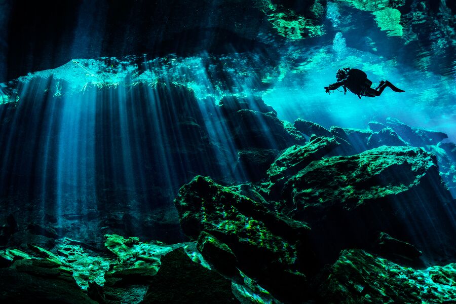 Scuba diver exploring the underwater cenotes.