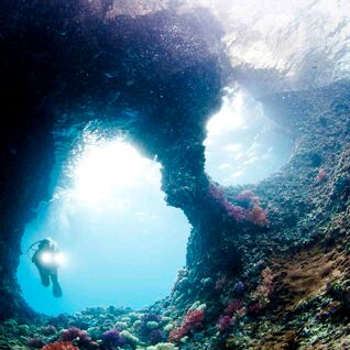Deep sea diver in underwater cave.